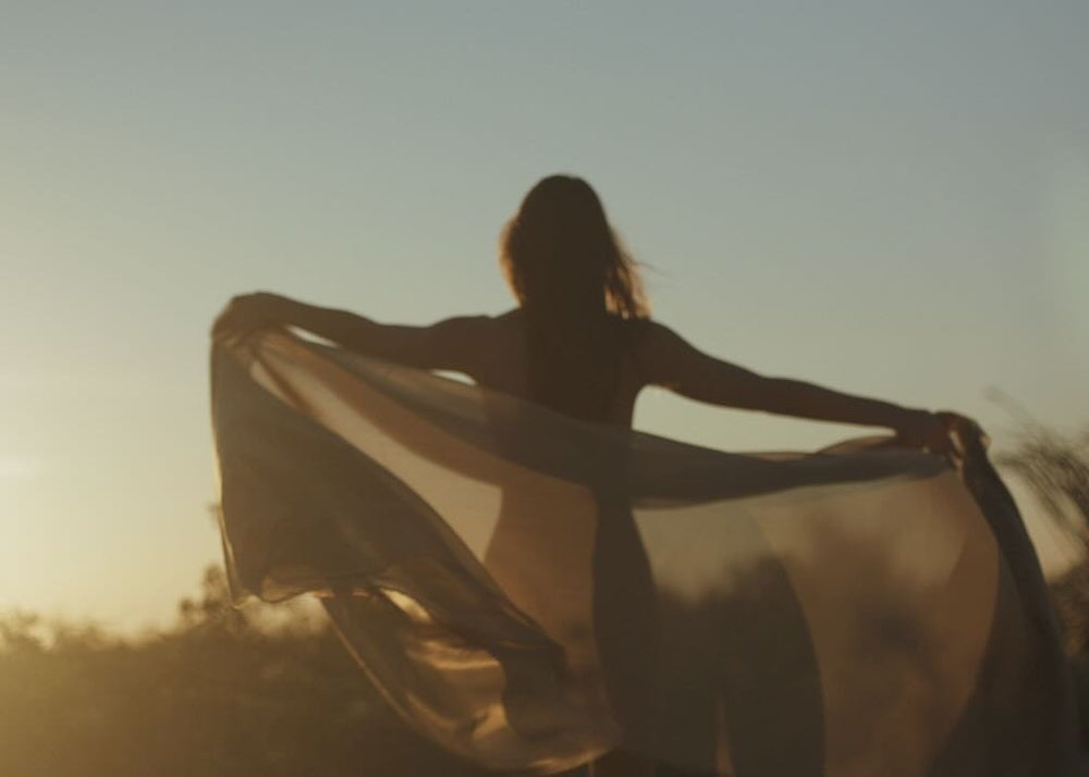  woman outdoors doing an abundance guided meditation 